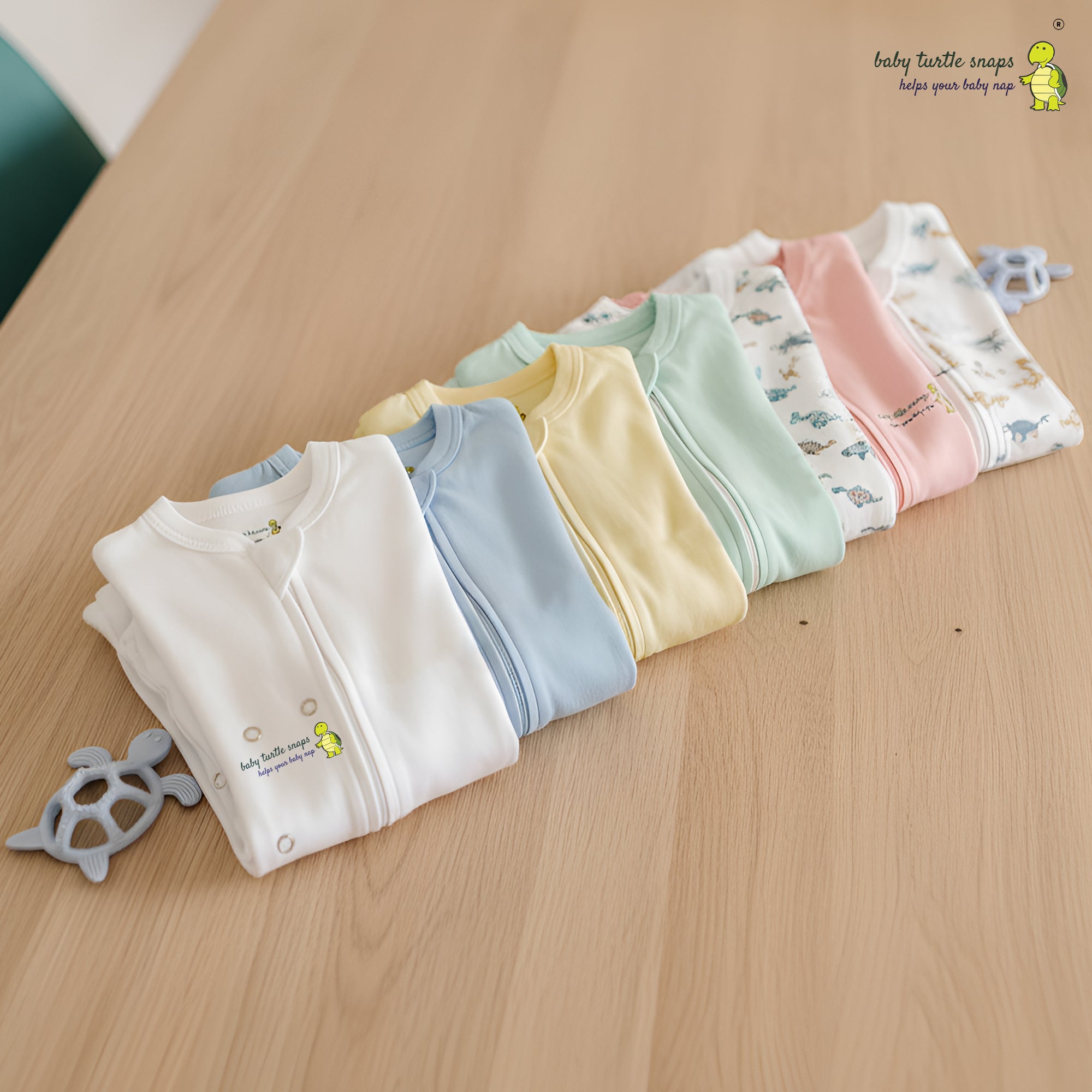 Baby cotton romper showing fold-over cuffs and zipper design.